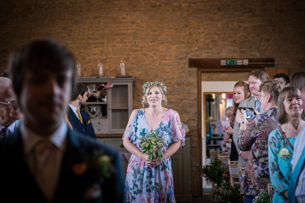 Bridesmaid walking down aisle